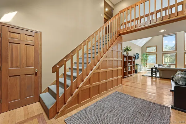 a view of entryway and hall with wooden floor