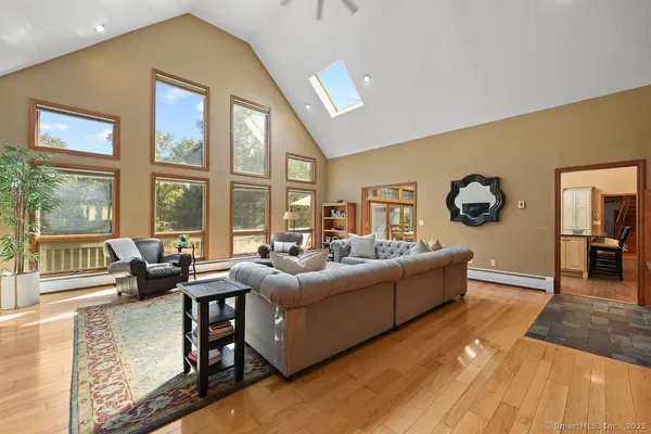 a living room with furniture and large windows