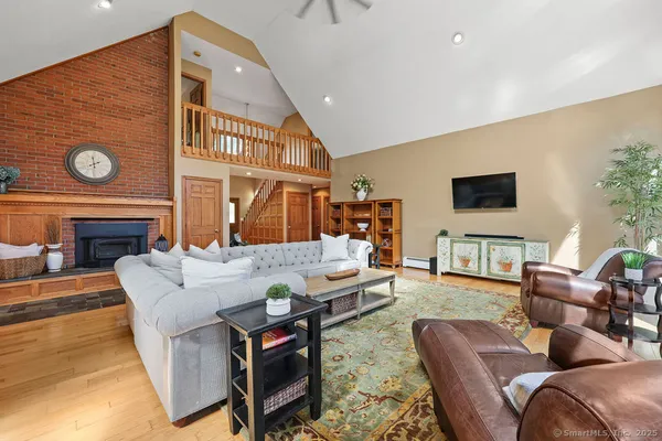 a living room with furniture a fireplace and a flat screen tv