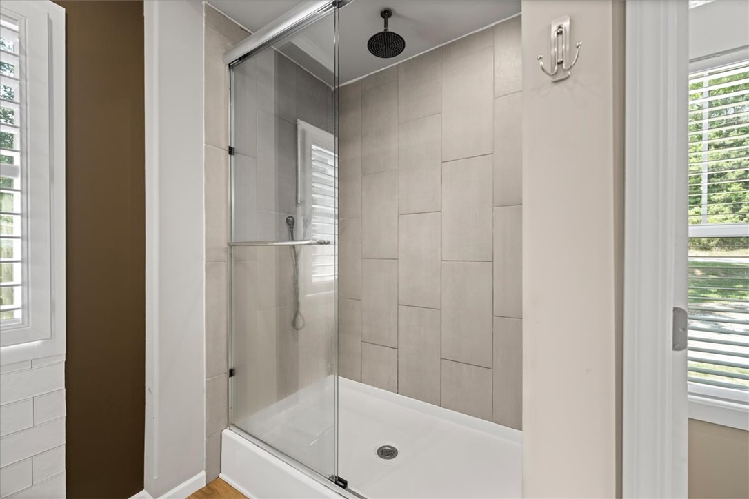 116 Parkview Road Iva, SC 29655 - Photo 25 of 44 Rainfall showerhead and modern tile create a serene bathing experience.