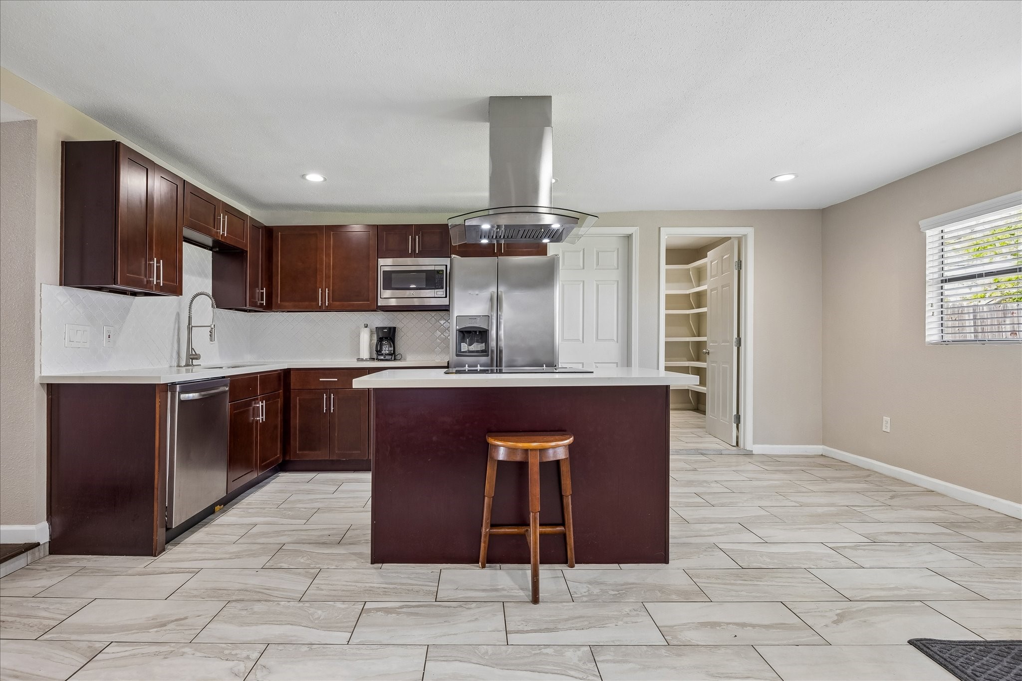 3817 Palm Street Houston, TX 77004 - Photo 3 of 15 a kitchen with stainless steel appliances granite countertop a stove a sink and a refrigerator