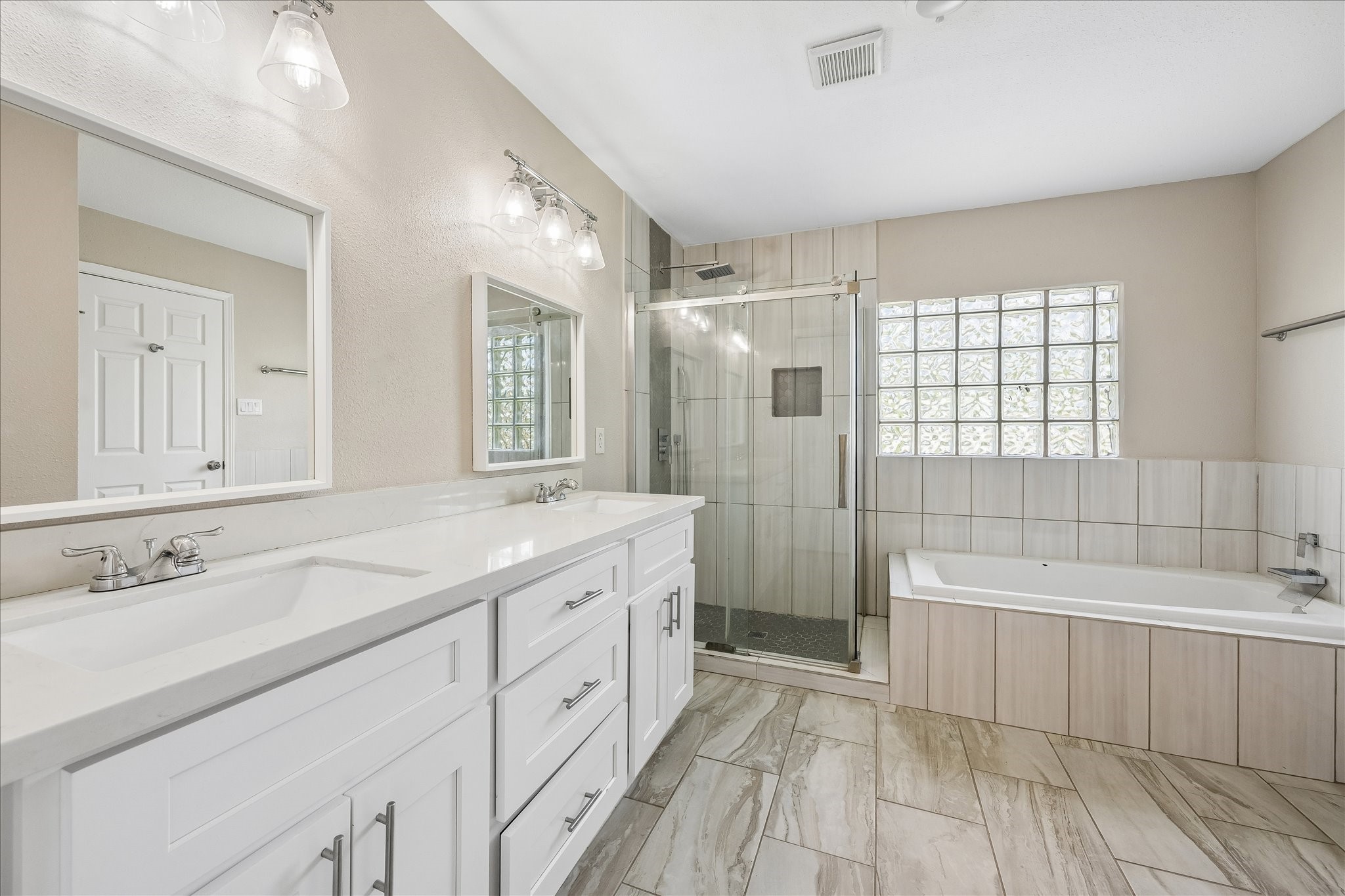 3817 Palm Street Houston, TX 77004 - Photo 10 of 15 a spacious bathroom with a tub sink shower and mirror