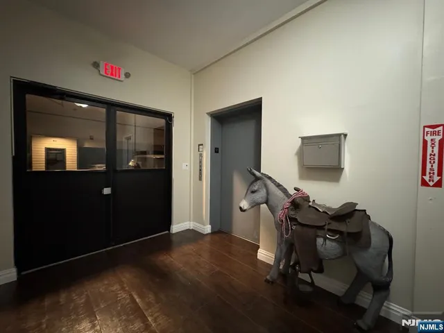 a view of a workspace with furniture and wooden floor