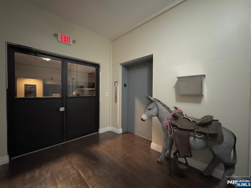 65 West Madison Avenue, Unit 4 Dumont, NJ 07628 - Photo 12 of 14 a room with furniture and wooden floor