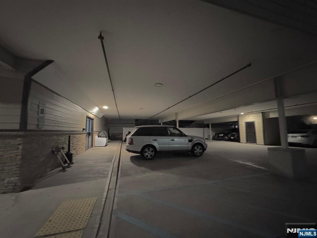 65 West Madison Avenue, Unit 4 Dumont, NJ 07628 - Photo 13 of 14 a view of parking garage with cars