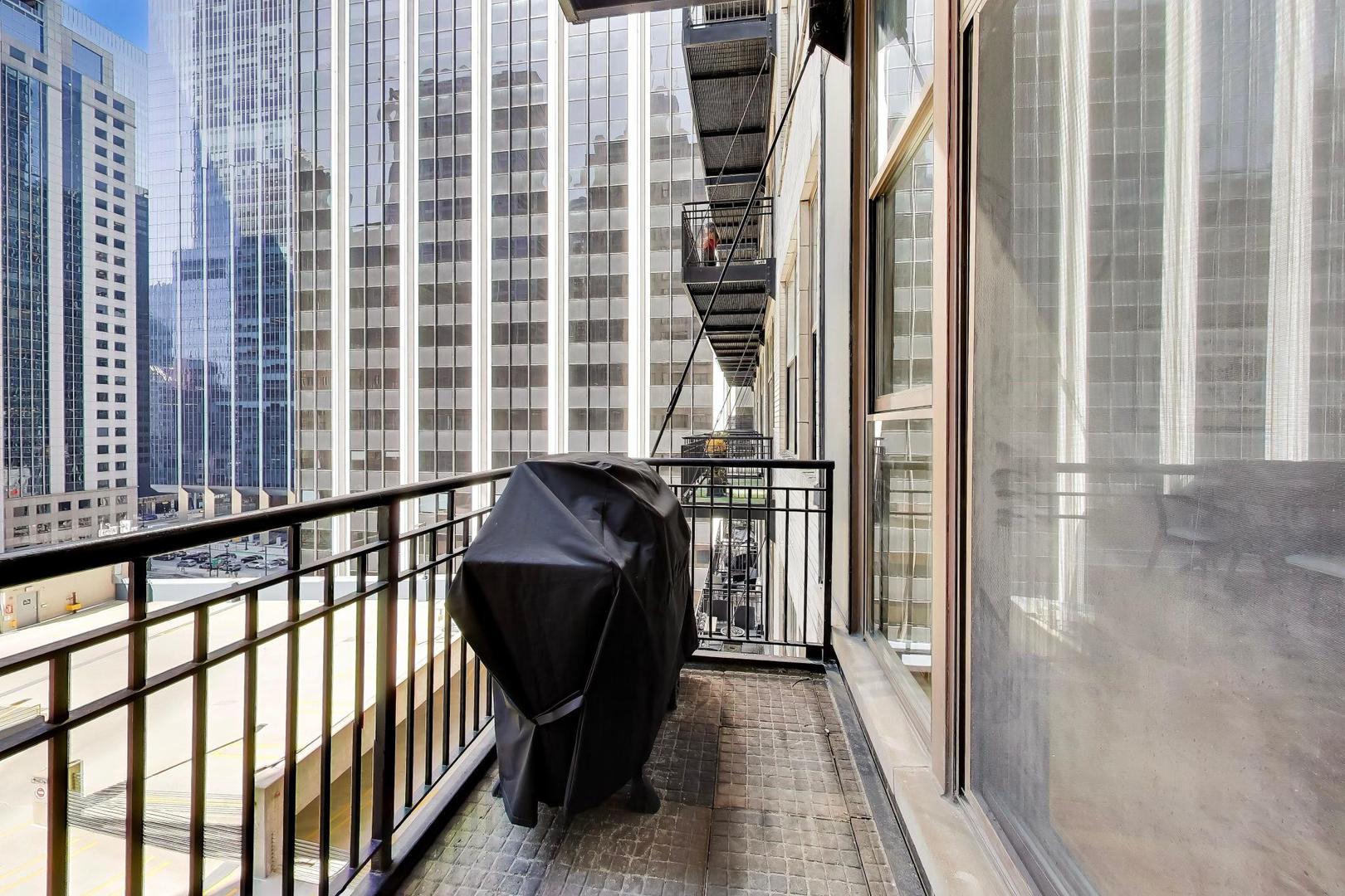 212 West Washington Street, Unit 908 Chicago, IL 60606 - Photo 23 of 32 a view of a balcony with furniture and floor to ceiling window