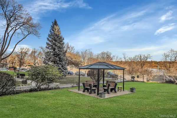 a view of a chair and table in the garden