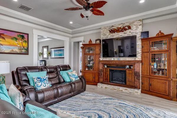 a living room with furniture a flat screen tv and a fireplace