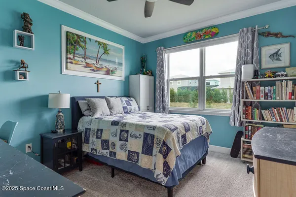 a bed sitting in a bedroom next to a window