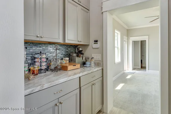 a view of a kitchen with sink and cabinets