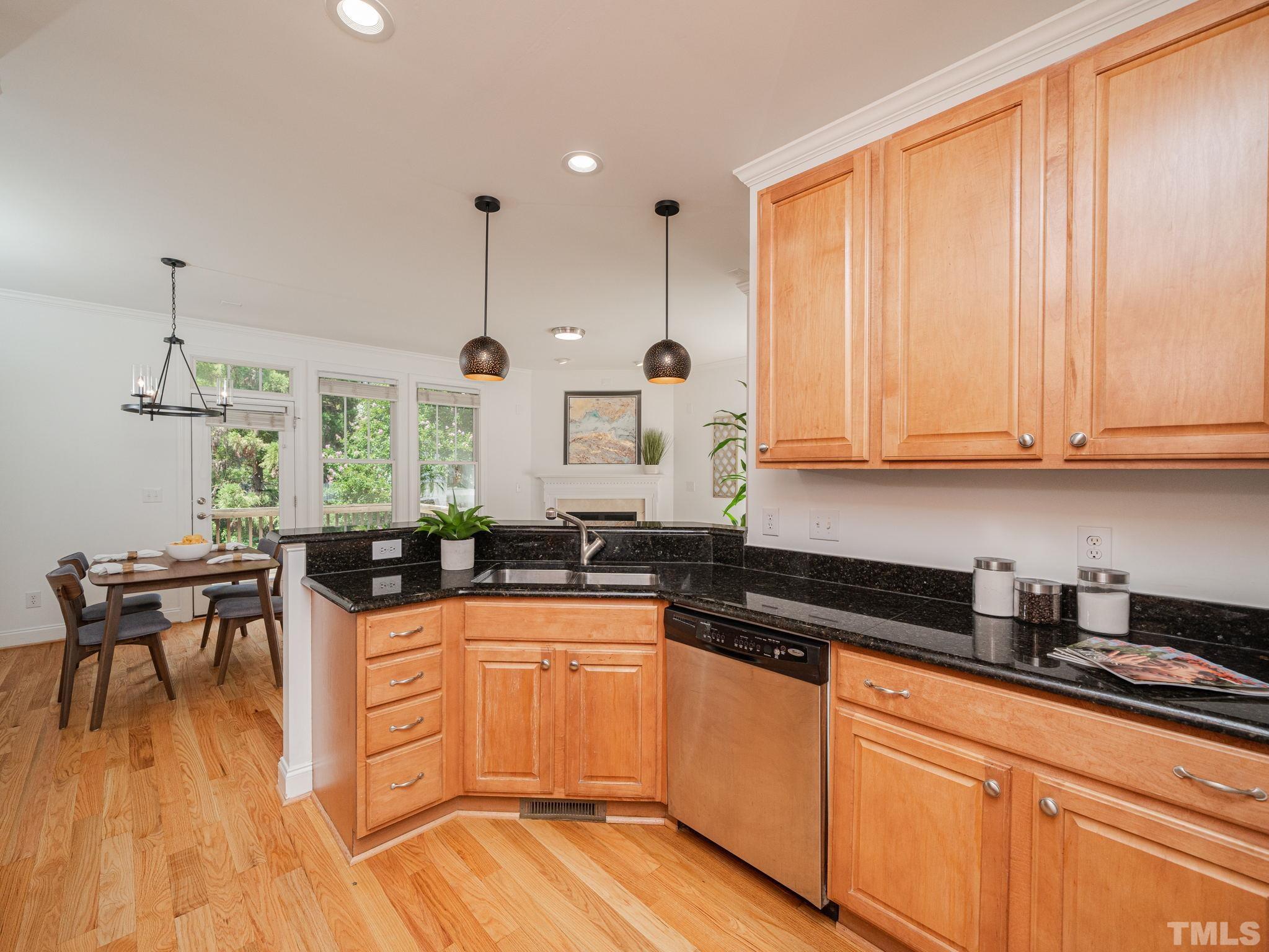 6109 Shandwick Court Raleigh, NC 27609 - Photo 12 of 36 a kitchen with granite countertop a sink a counter space appliances and cabinets