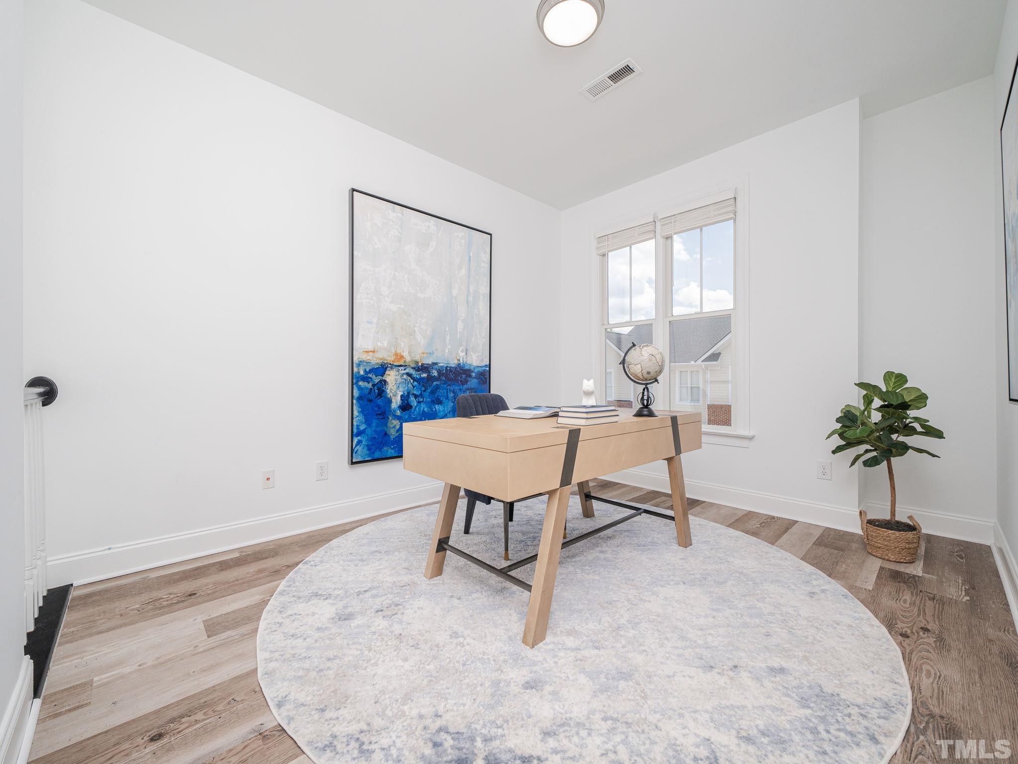6109 Shandwick Court Raleigh, NC 27609 - Photo 21 of 36 a living room with furniture and a potted plant