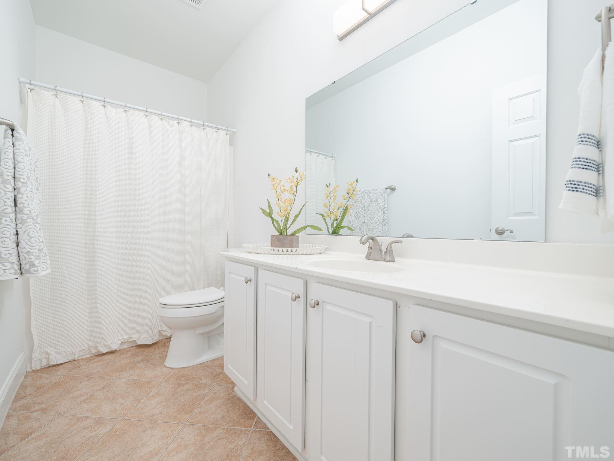 6109 Shandwick Court Raleigh, NC 27609 - Photo 23 of 36 a bathroom with a granite countertop sink and a toilet