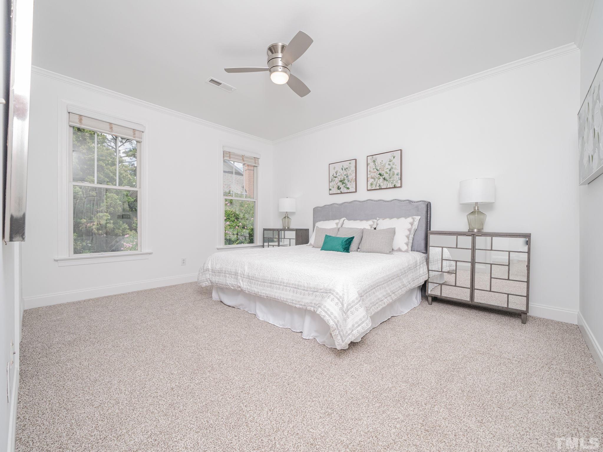 6109 Shandwick Court Raleigh, NC 27609 - Photo 25 of 36 a spacious bedroom with a bed a window and closet