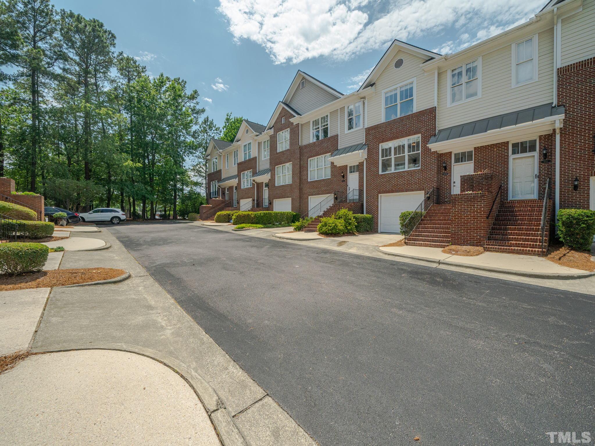 6109 Shandwick Court Raleigh, NC 27609 - Photo 3 of 36 a street view with building and trees in the background