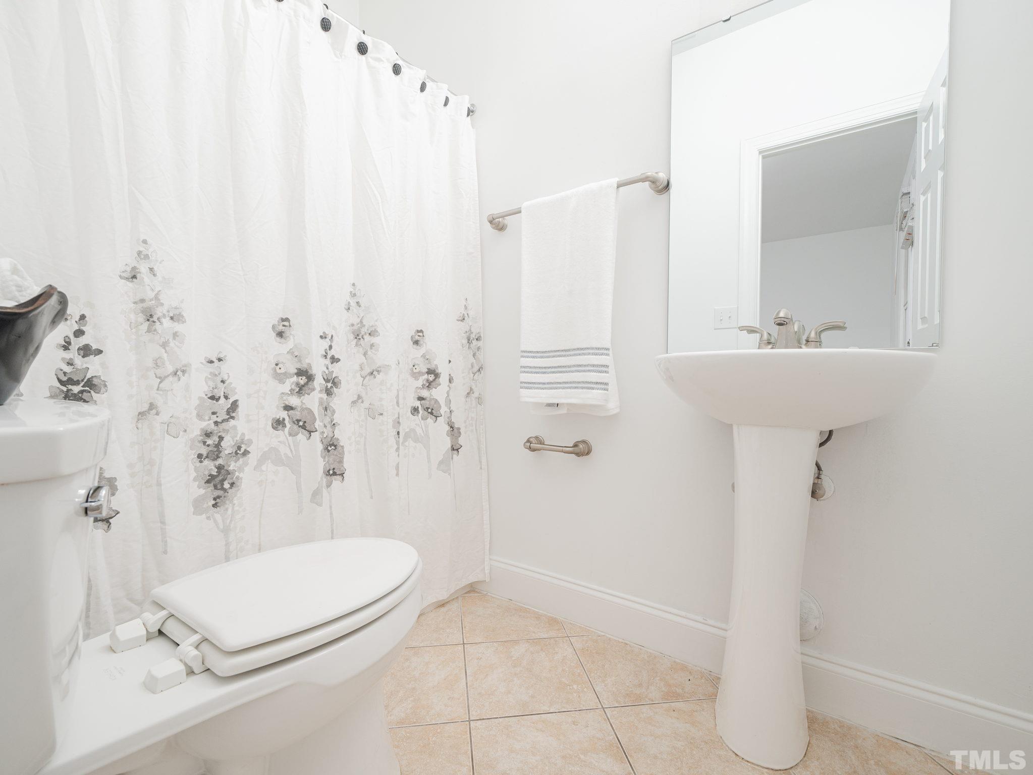 6109 Shandwick Court Raleigh, NC 27609 - Photo 32 of 36 a bathroom with a sink a toilet and shower