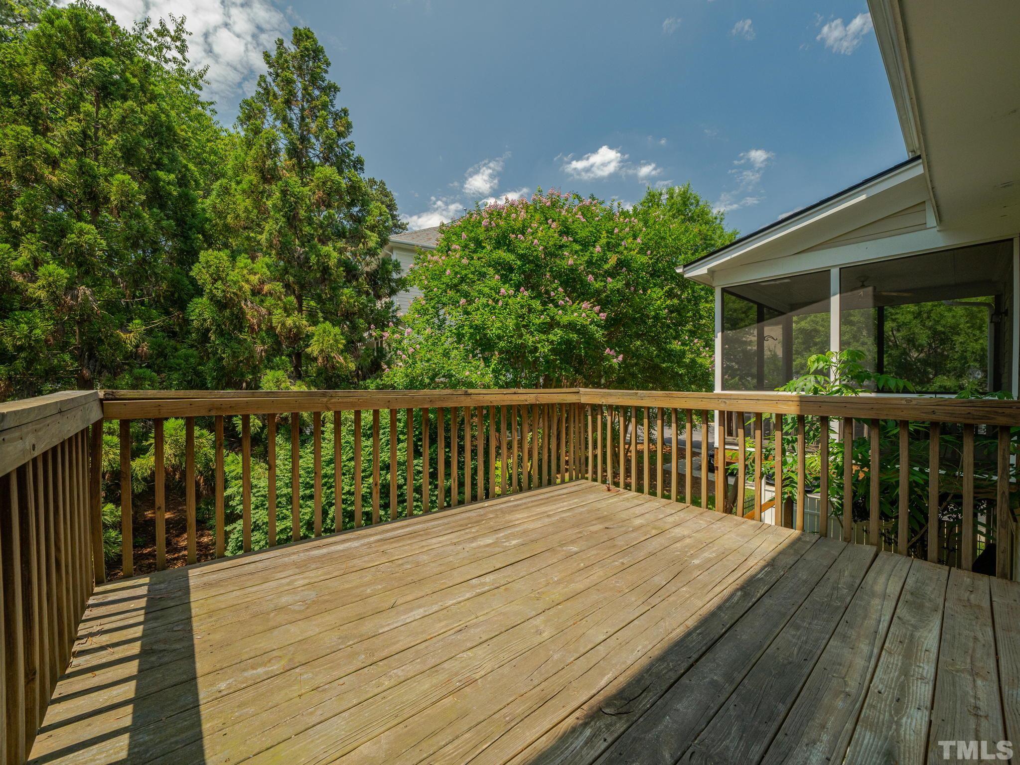6109 Shandwick Court Raleigh, NC 27609 - Photo 33 of 36 a balcony with wooden floor and trees in the back