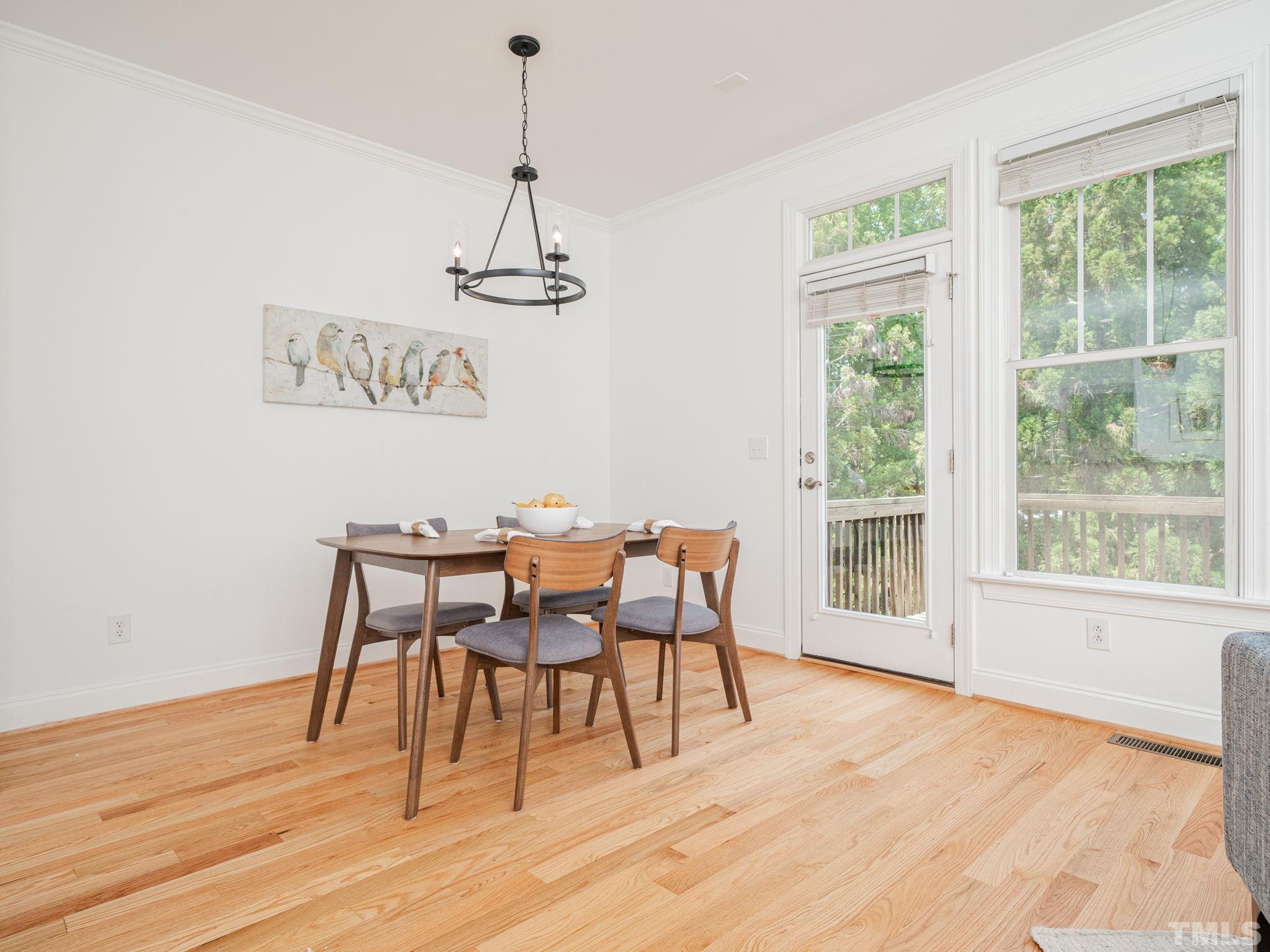 6109 Shandwick Court Raleigh, NC 27609 - Photo 7 of 36 a view of a dining room with furniture window and wooden floor