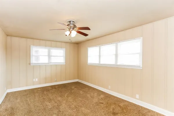 a view of empty room with ceiling fan