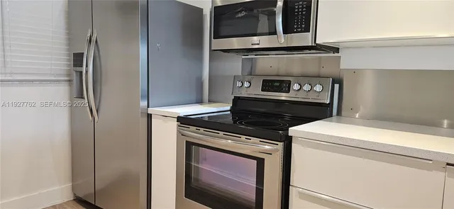 a stove top oven sitting inside of a kitchen