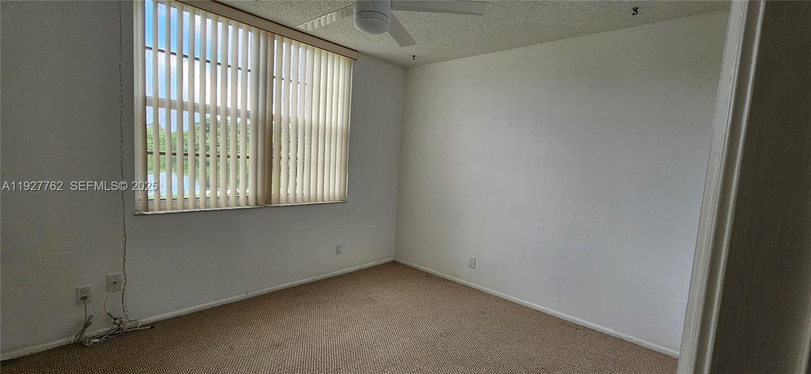 9450 Poinciana Place, Unit 103 Davie, FL 33324 - Photo 16 of 30 a view of an empty room with a window