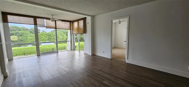 a kitchen with a sink cabinets and wooden floor