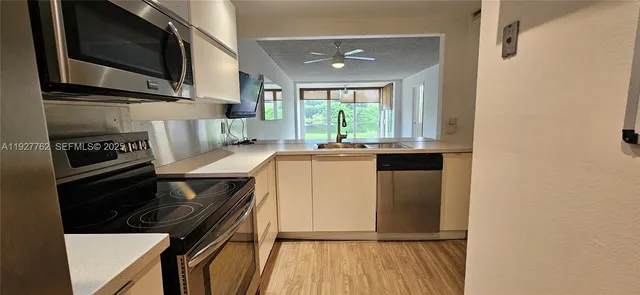 a kitchen with a refrigerator stove and sink