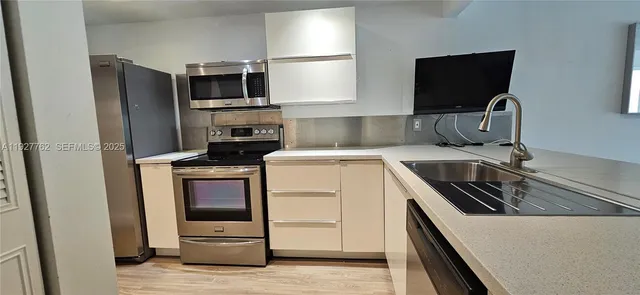 a room with a flat screen tv and chairs