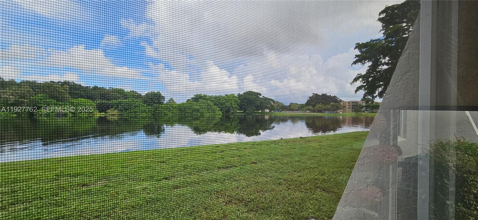 9450 Poinciana Place, Unit 103 Davie, FL 33324 - Photo 29 of 30 a view of a lake with a lake view