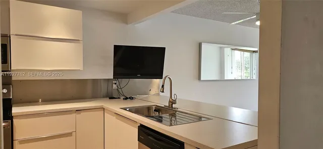a kitchen with a sink cabinets and window
