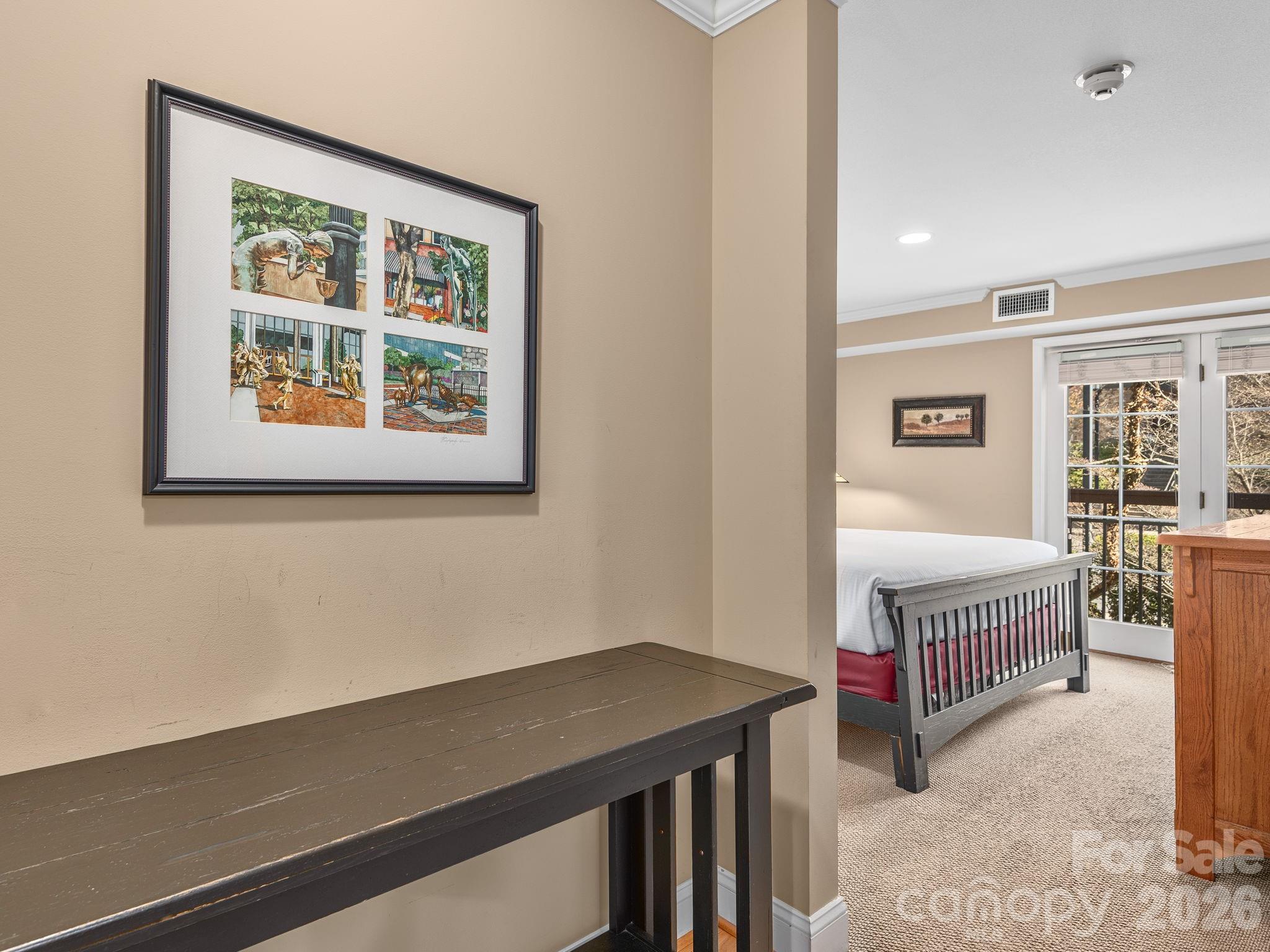 307 Bowling Park Road Asheville, NC 28803 - Photo 13 of 19 a view of a bedroom with wooden floor and windows
