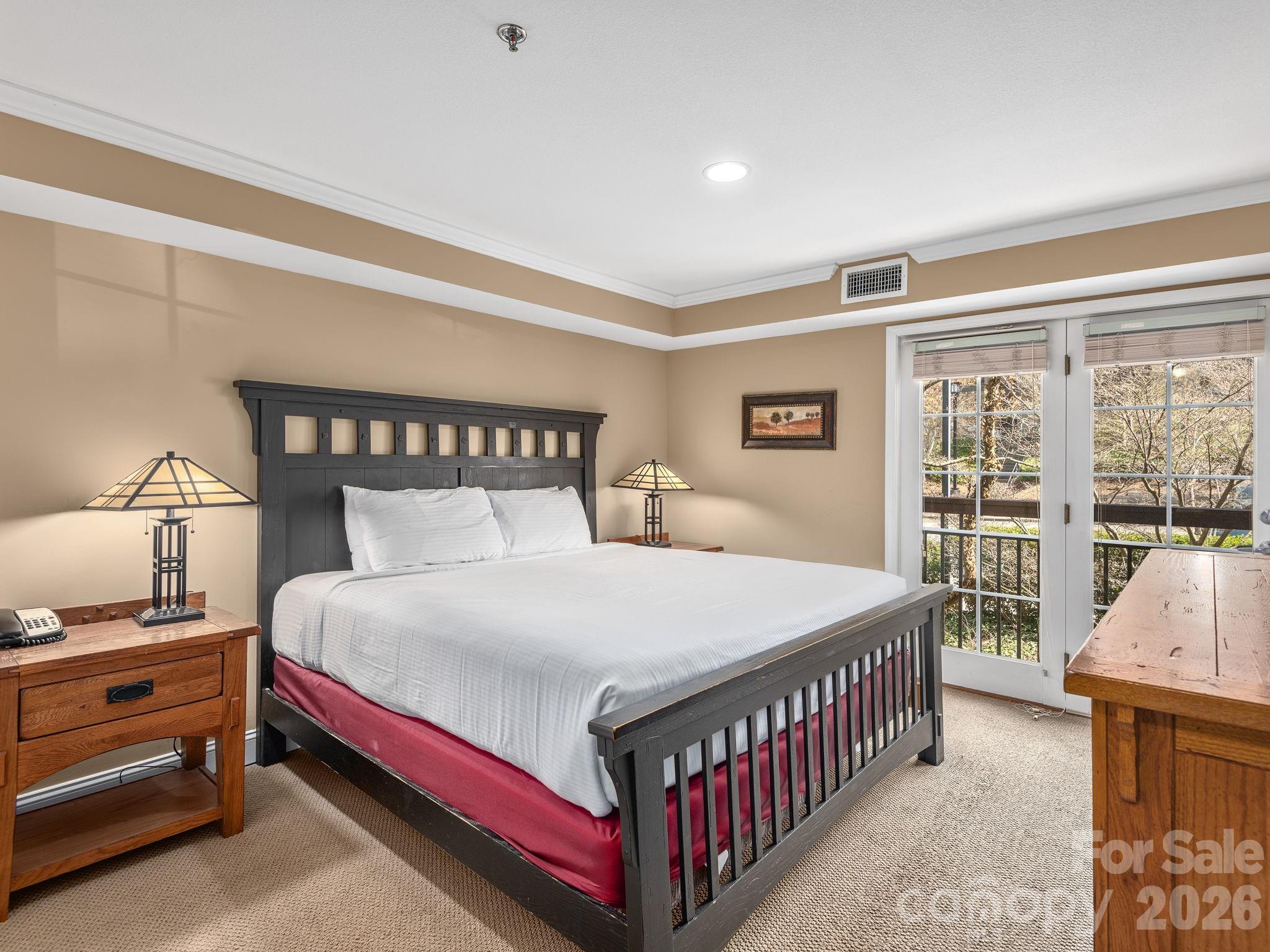 307 Bowling Park Road Asheville, NC 28803 - Photo 14 of 19 a bedroom with a bed and a large window