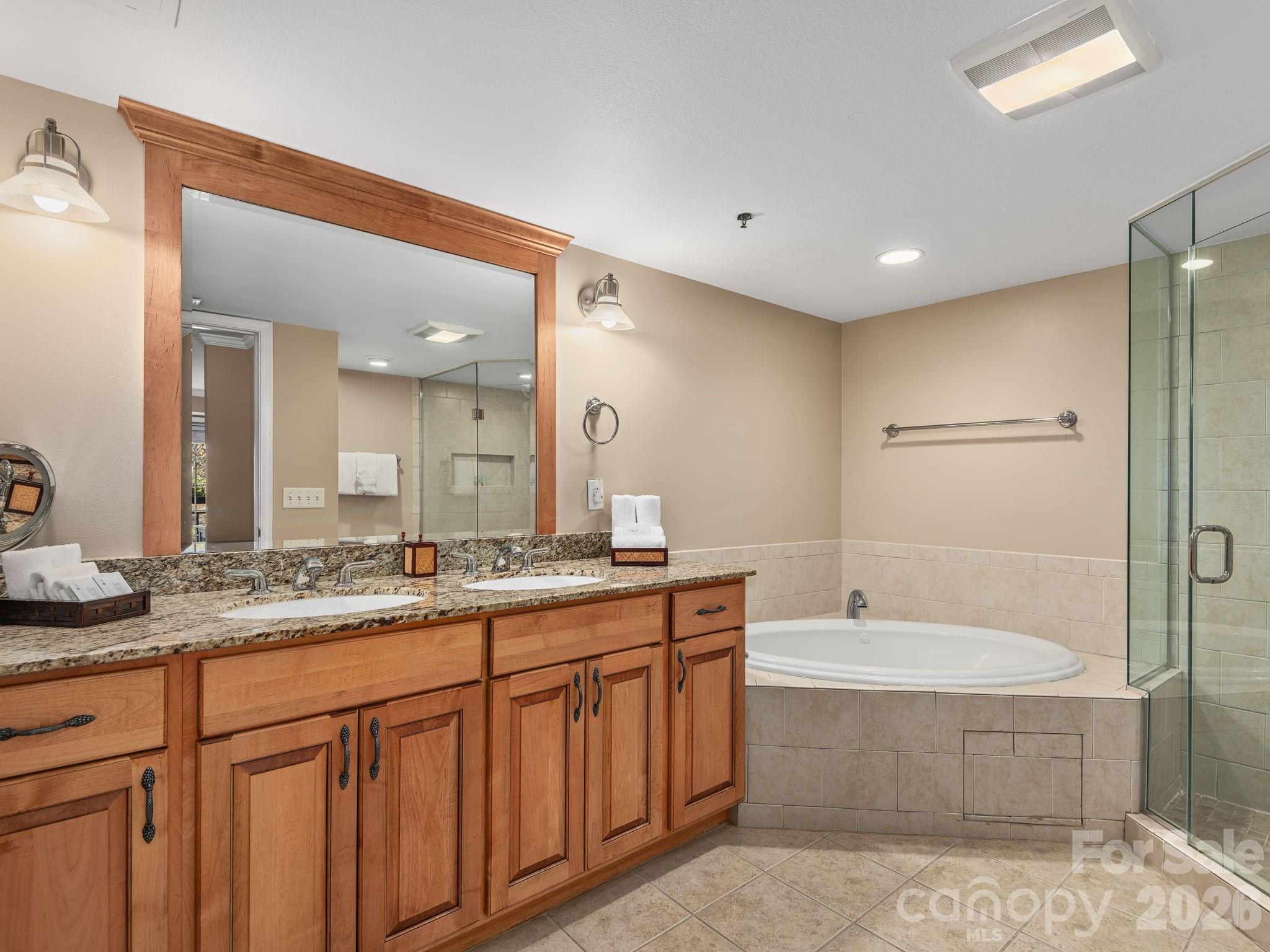 307 Bowling Park Road Asheville, NC 28803 - Photo 15 of 19 a bathroom with a granite countertop sink mirror and bathtub