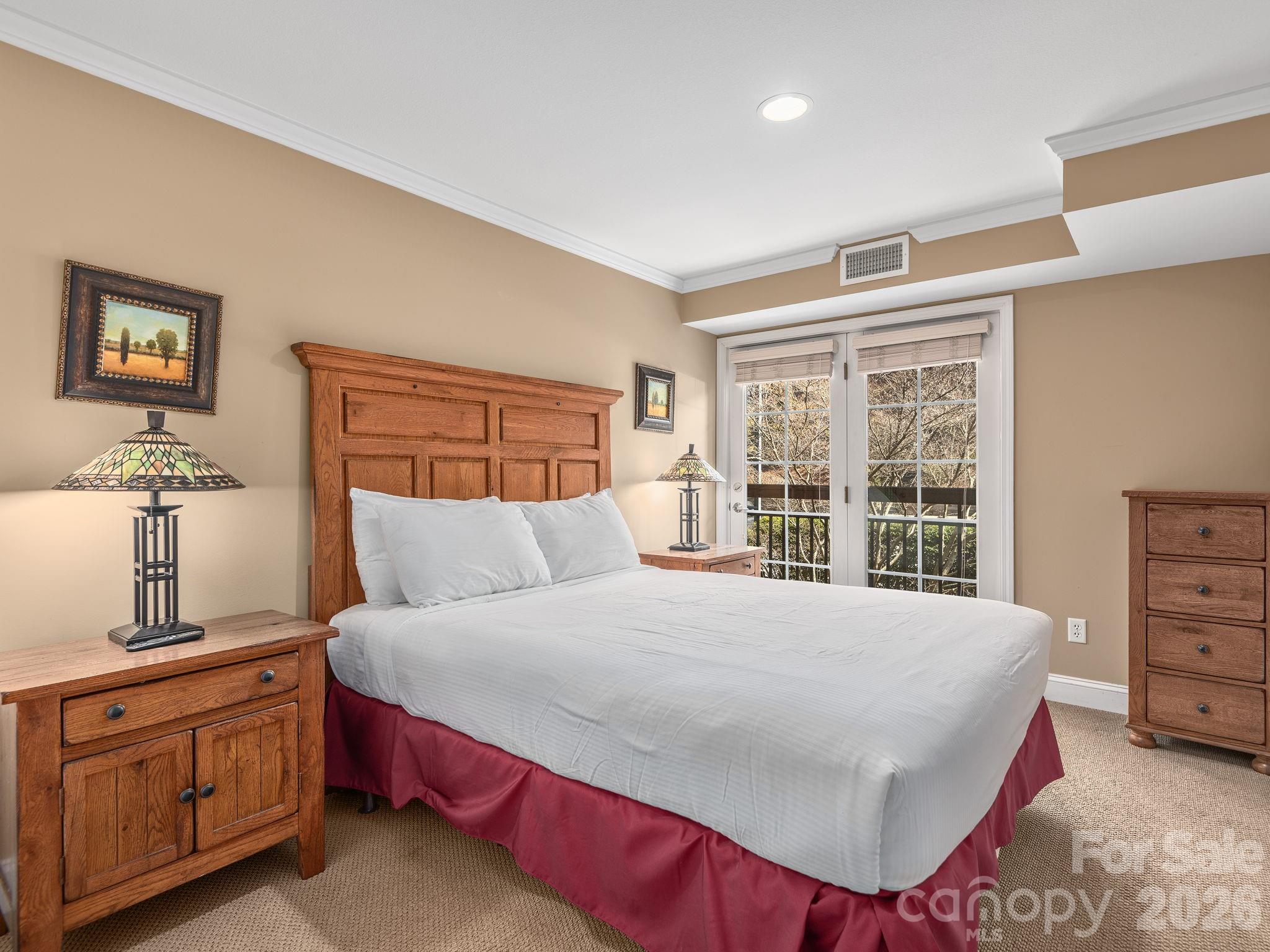 307 Bowling Park Road Asheville, NC 28803 - Photo 17 of 19 a bedroom with a large bed and a dresser