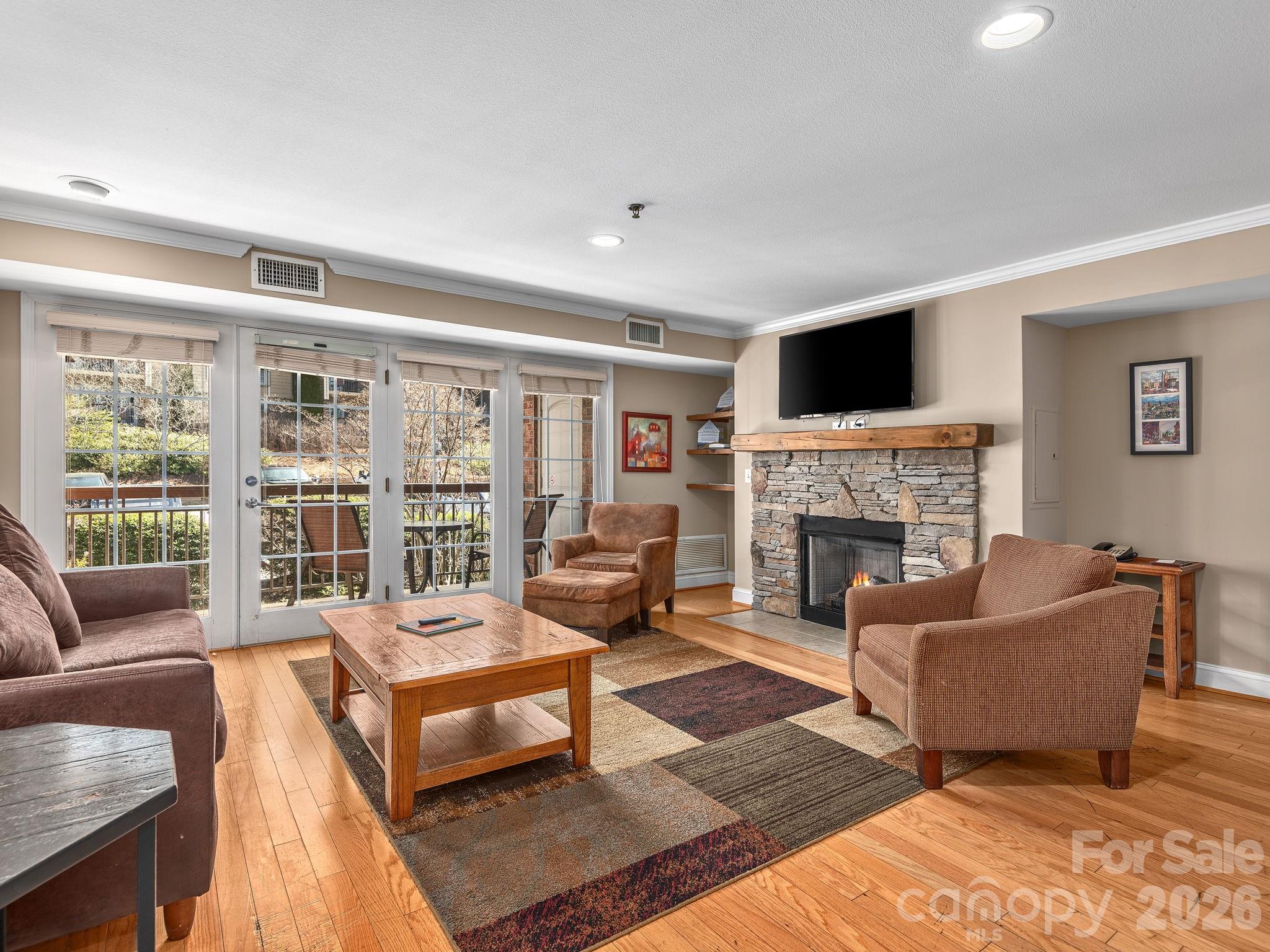 307 Bowling Park Road Asheville, NC 28803 - Photo 3 of 19 a living room with furniture and a fireplace