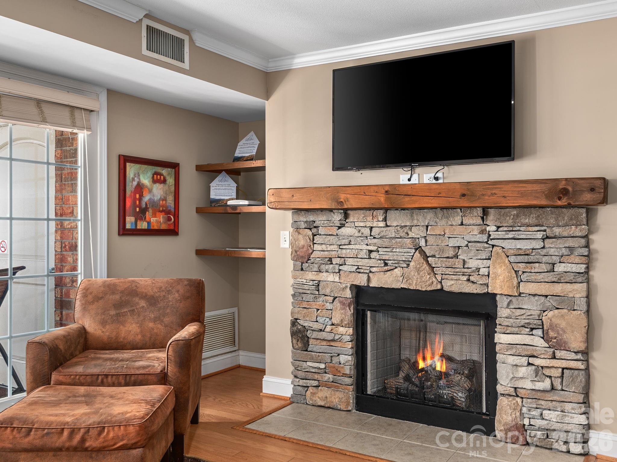 307 Bowling Park Road Asheville, NC 28803 - Photo 4 of 19 a living room with furniture and a fireplace