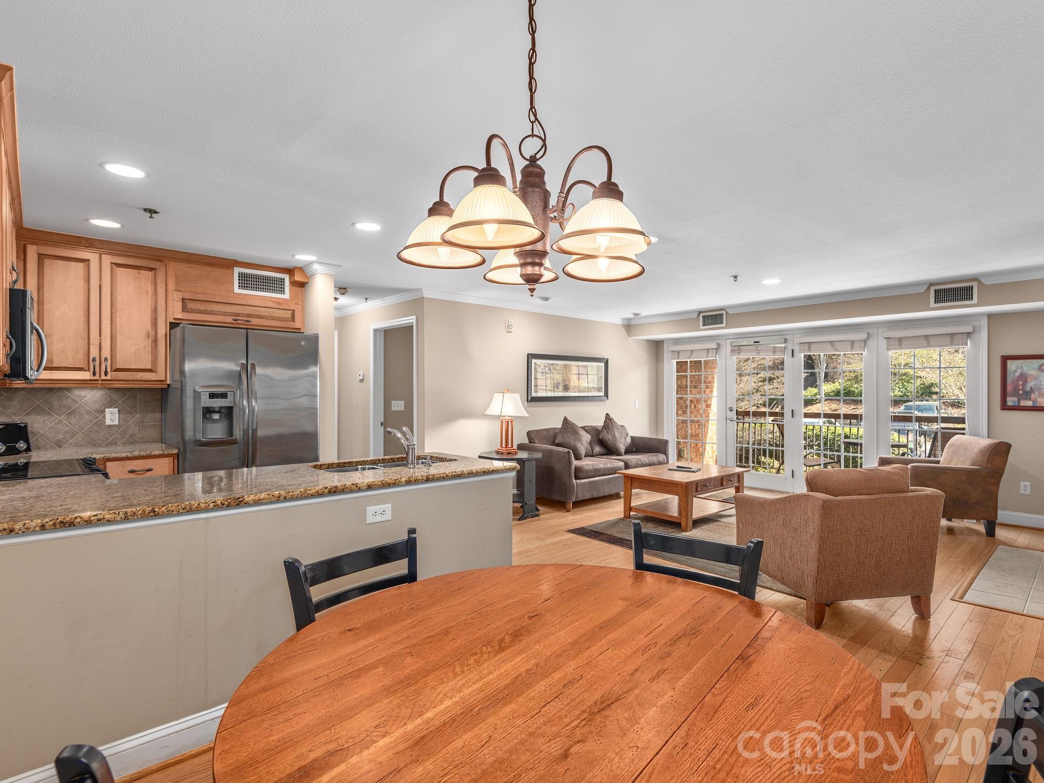 307 Bowling Park Road Asheville, NC 28803 - Photo 7 of 19 a living room with stainless steel appliances granite countertop furniture a fireplace a flat screen tv and a large window