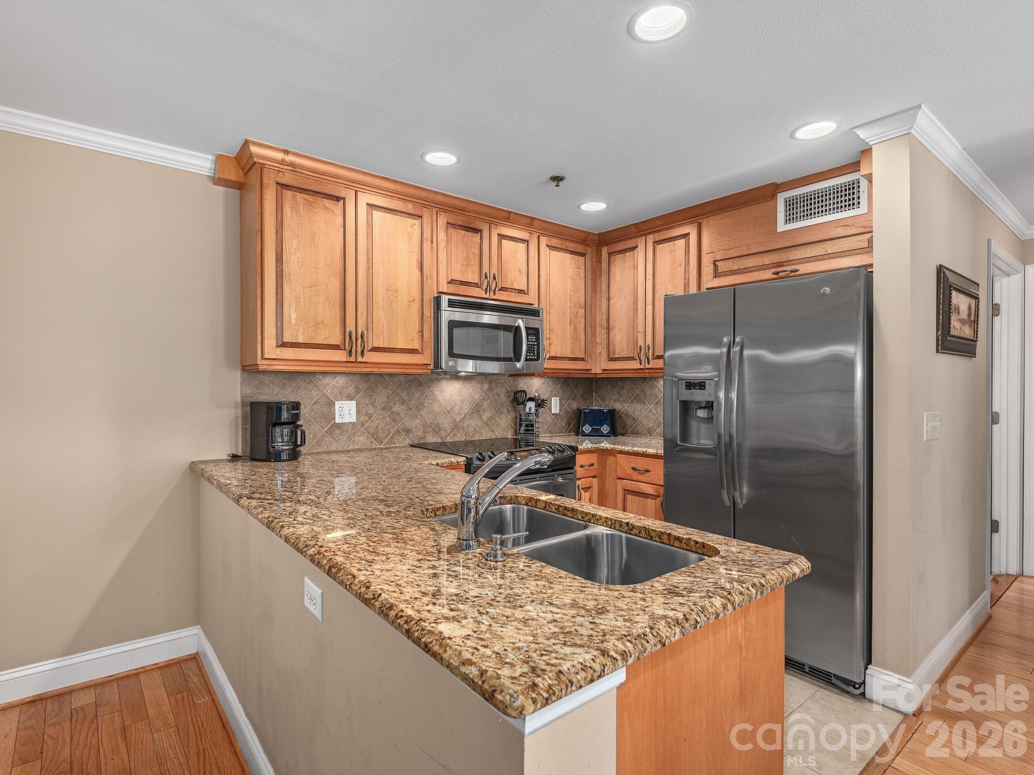 307 Bowling Park Road Asheville, NC 28803 - Photo 8 of 19 a kitchen with stainless steel appliances granite countertop a sink stove and refrigerator
