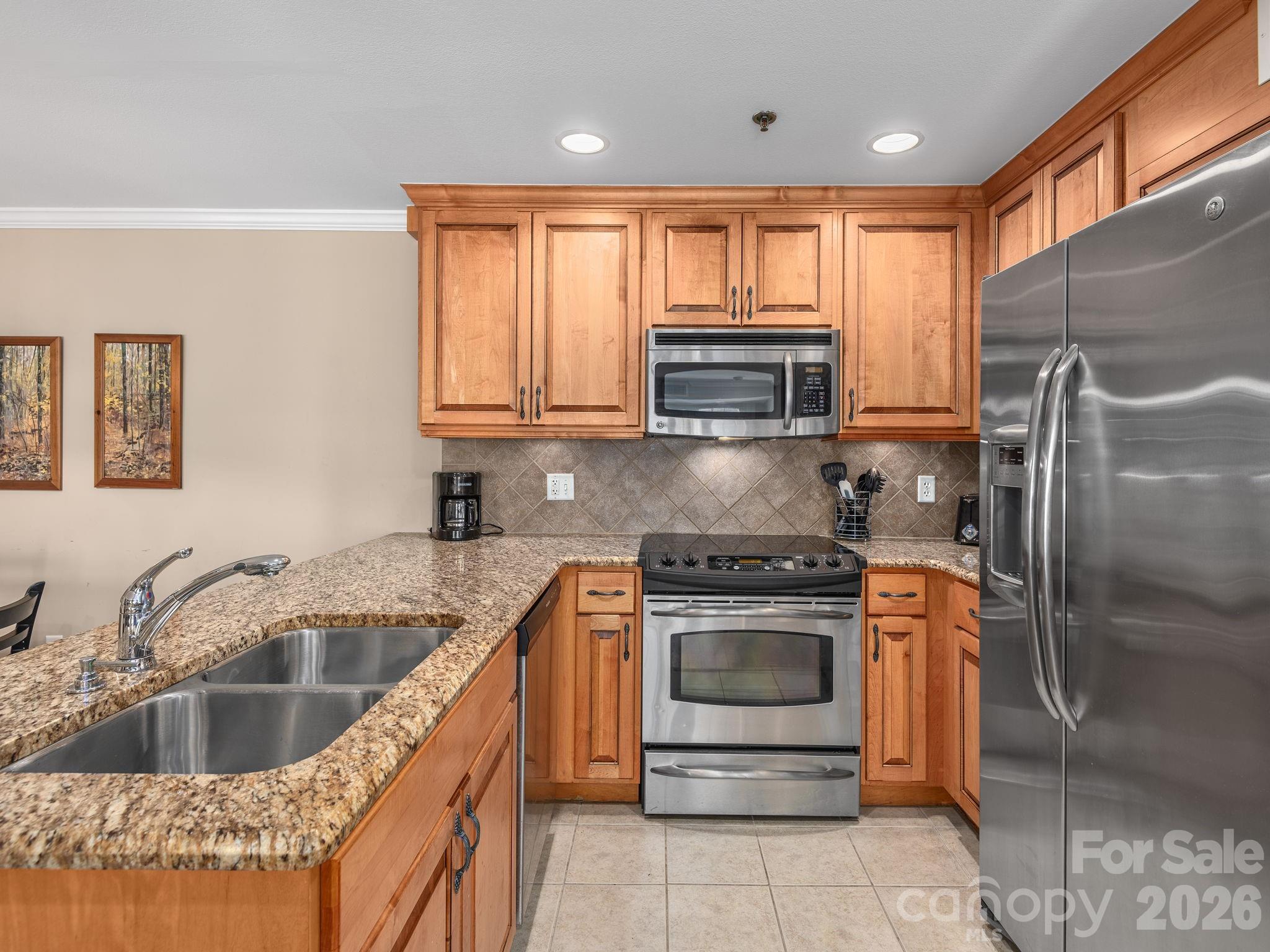 307 Bowling Park Road Asheville, NC 28803 - Photo 9 of 19 a kitchen with a stove a sink and a microwave