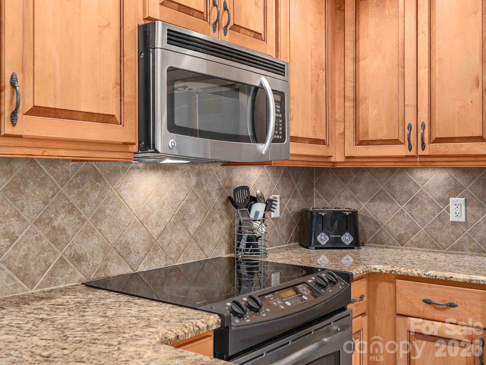 307 Bowling Park Road Asheville, NC 28803 - Photo 10 of 19 a kitchen with granite countertop a stove and a sink