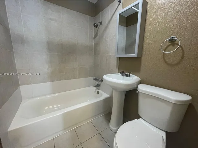 a bathroom with a sink a toilet and a bathtub