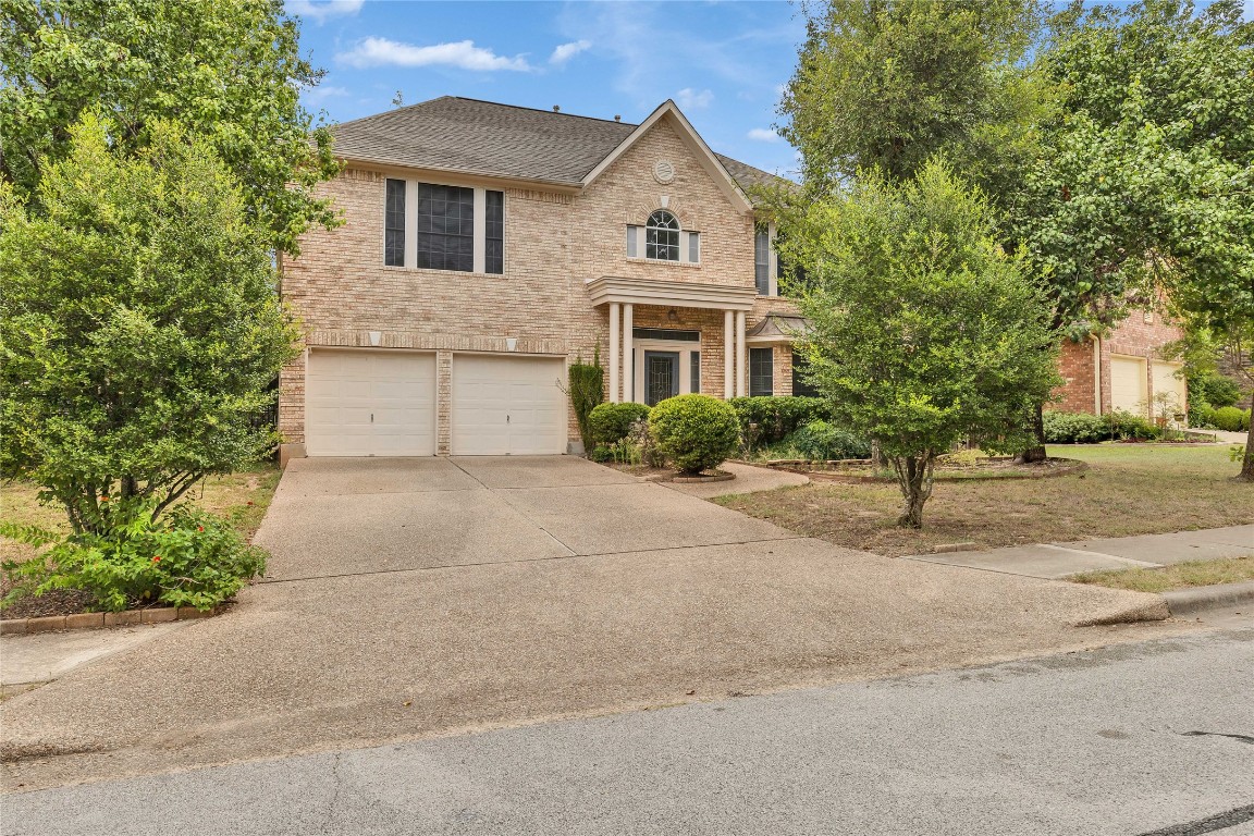 5407 Merrywing Circle Austin, TX 78730 - Photo 1 of 36 View of front of house featuring brick siding, concrete driveway, a shingled roof, and an attached garage