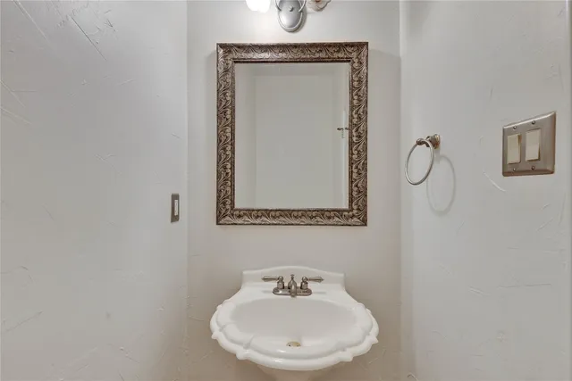 a bathroom with a sink a mirror and shower