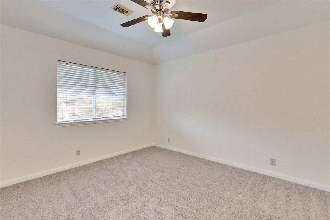 5407 Merrywing Circle Austin, TX 78730 - Photo 22 of 36 Unfurnished room featuring light carpet and a ceiling fan