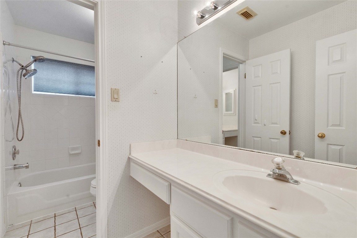 5407 Merrywing Circle Austin, TX 78730 - Photo 25 of 36 Full bath with wallpapered walls, vanity, light tile patterned floors, and shower combination