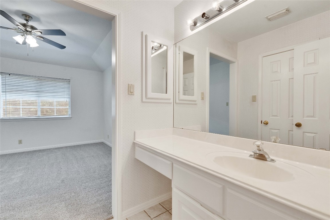 5407 Merrywing Circle Austin, TX 78730 - Photo 27 of 36 Bathroom with vaulted ceiling, vanity, ceiling fan, and light colored carpet
