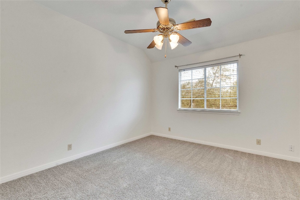 5407 Merrywing Circle Austin, TX 78730 - Photo 28 of 36 Empty room featuring vaulted ceiling, light colored carpet, and a ceiling fan