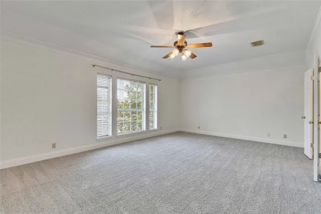 a view of room with a ceiling fan and window