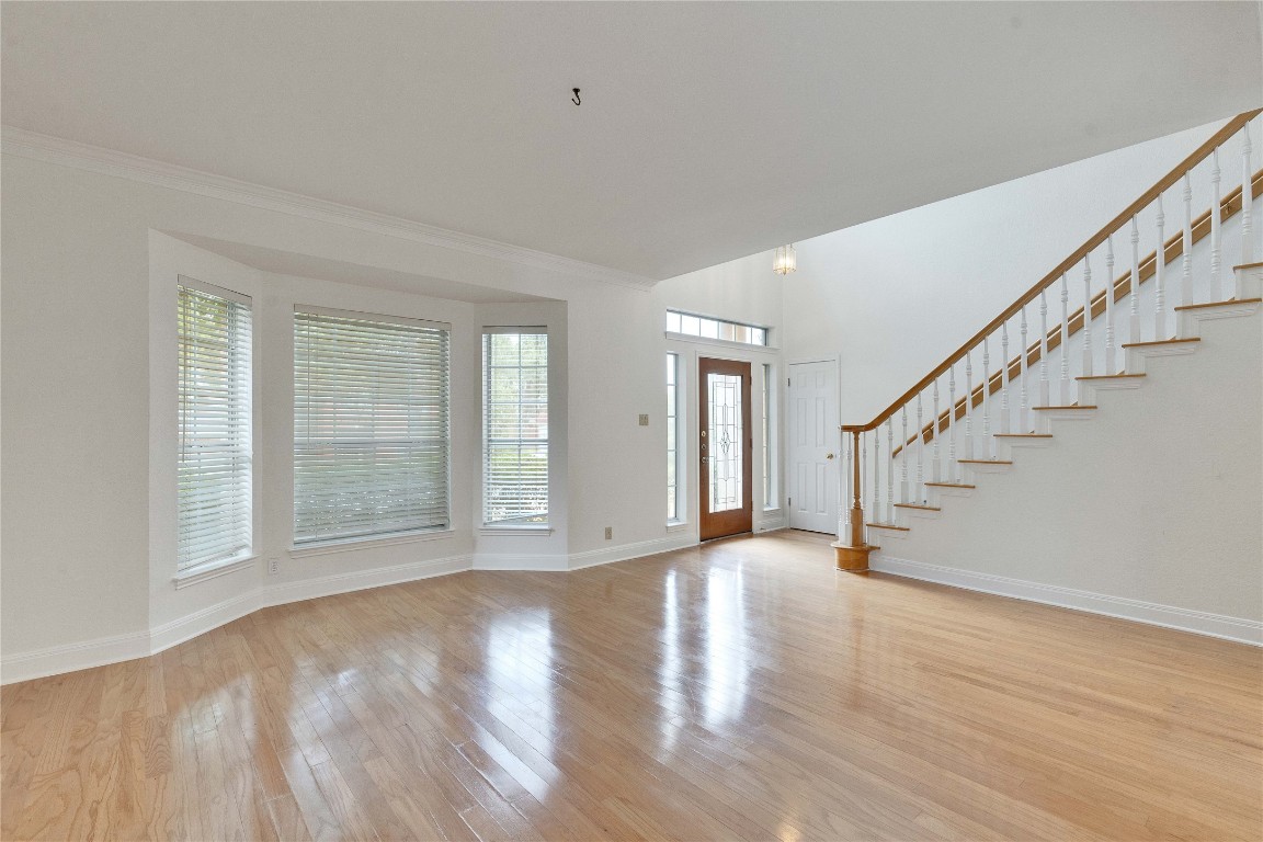 5407 Merrywing Circle Austin, TX 78730 - Photo 9 of 36 Entryway featuring light wood-style flooring and stairs