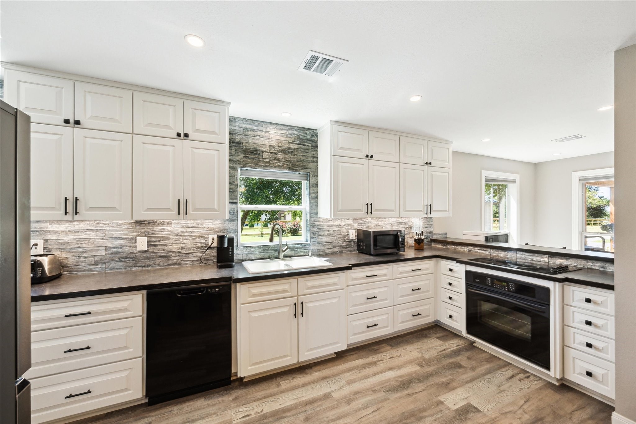 6063 Fm 1094 Sealy, TX 77474 - Photo 21 of 47 a kitchen with granite countertop white cabinets white stainless steel appliances with a sink and dishwasher
